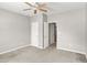 Neutral bedroom featuring carpet flooring, ceiling fan, and closet, with a door into the hallway at 61 Larimar Way, Whiteland, IN 46184
