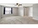 Spacious bedroom with a ceiling fan, window, and plush carpeting at 61 Larimar Way, Whiteland, IN 46184