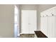 Entryway with a mudroom bench, double closet doors, and an entrance to another room at 61 Larimar Way, Whiteland, IN 46184