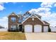Beautiful two-story brick home with a three-car garage, blue accents, and manicured landscaping at 61 Larimar Way, Whiteland, IN 46184
