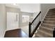 Inviting foyer with a staircase, hardwood flooring, natural light, and an open view into the living space at 61 Larimar Way, Whiteland, IN 46184