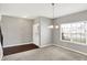 Bright room featuring a large window, modern light fixture, and tiled entry with neutral paint at 61 Larimar Way, Whiteland, IN 46184