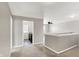 Upstairs hallway with carpet flooring, access to laundry room, and view into another room at 61 Larimar Way, Whiteland, IN 46184