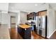 Stylish kitchen with wood island, stainless steel appliances, dark cabinetry, and generous counter space at 61 Larimar Way, Whiteland, IN 46184