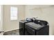 Functional laundry room with modern washer and dryer, tile floor, and natural light at 61 Larimar Way, Whiteland, IN 46184