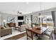 Open concept living area boasting a fireplace, a dining table, hardwood floors, and access to the backyard at 61 Larimar Way, Whiteland, IN 46184