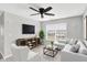 Comfortable living room features a sectional sofa, large windows, and a modern entertainment center at 61 Larimar Way, Whiteland, IN 46184