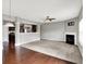 Spacious living room with fireplace, ceiling fan, and an open design to the kitchen at 61 Larimar Way, Whiteland, IN 46184