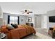 Comfortable main bedroom featuring neutral walls, a ceiling fan, and a large bed with colorful pillows at 61 Larimar Way, Whiteland, IN 46184