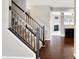 View of carpeted stairs with wooden railing and view of the Gathering room through the hallway at 61 Larimar Way, Whiteland, IN 46184
