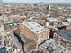 Expansive aerial shot highlighting the building's roof and surrounding neighborhood, city in the distance at 611 N Park Ave # 414, Indianapolis, IN 46204