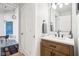 Bathroom vanity with modern faucet and a view into an adjacent dining area at 611 N Park Ave # 414, Indianapolis, IN 46204