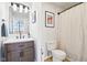 Bathroom featuring a vanity with modern fixtures and a shower with stylish curtain at 611 N Park Ave # 414, Indianapolis, IN 46204