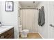 Bathroom with neutral tile flooring and a shower with a decorative curtain at 611 N Park Ave # 414, Indianapolis, IN 46204