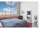 Bright bedroom features a huge window with city views and an inviting seating area leading to the living room at 611 N Park Ave # 414, Indianapolis, IN 46204