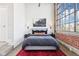 Modern bedroom with large windows, neutral colors, and stylish decor at 611 N Park Ave # 414, Indianapolis, IN 46204