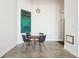 Modern dining area with seating for four, artwork and concrete floors at 611 N Park Ave # 414, Indianapolis, IN 46204