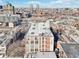 Aerial view highlighting the industrial building's rooftop details with city skyline backdrop at 611 N Park Ave # 414, Indianapolis, IN 46204