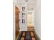 Hallway with pictures, interior door, and bathroom in a bright, modern condominium at 611 N Park Ave # 414, Indianapolis, IN 46204