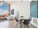 Bright living and dining area with concrete floors and large industrial windows overlooking the city at 611 N Park Ave # 414, Indianapolis, IN 46204