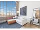 Modern condo living room with exposed brick, large windows, and decor at 611 N Park Ave # 414, Indianapolis, IN 46204