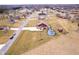 Aerial view of a home in a rural neighborhood, with a spacious yard, pool, and outbuilding at 6880 W Jennifer Dr, Greenfield, IN 46140