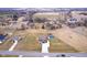 Expansive aerial view of home with a large lawn, pool, red barn, and lengthy driveway in a quiet, secluded neighborhood at 6880 W Jennifer Dr, Greenfield, IN 46140