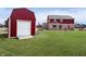 View of the home's backyard, including a large storage barn and well-maintained lawn at 6880 W Jennifer Dr, Greenfield, IN 46140