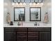 Double vanity bathroom features neutral colors, great lighting, and dual mirrors at 6880 W Jennifer Dr, Greenfield, IN 46140