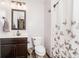 Cozy bathroom with butterfly shower curtain, dark wood vanity, and neutral wall paint at 6880 W Jennifer Dr, Greenfield, IN 46140