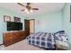 Comfortable bedroom with ceiling fan, neutral walls, and a dresser with mounted television at 6880 W Jennifer Dr, Greenfield, IN 46140