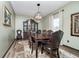 Elegant dining room with a large wooden table, chandelier, and decorative hutch at 6880 W Jennifer Dr, Greenfield, IN 46140