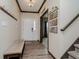 Welcoming entryway featuring wood-look flooring, coat hooks, staircase, and decorative wall art at 6880 W Jennifer Dr, Greenfield, IN 46140