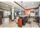 Open kitchen with granite island, stainless appliances, dark cabinets, and wood-look floors at 6880 W Jennifer Dr, Greenfield, IN 46140