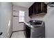 Modern laundry room with stainless steel washer and dryer, and custom cabinet at 6880 W Jennifer Dr, Greenfield, IN 46140