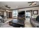 Spacious living room features wood floors, a ceiling fan, and a large flatscreen TV at 6880 W Jennifer Dr, Greenfield, IN 46140
