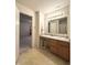 Bright bathroom featuring vanity with sink, cabinet storage, and view into bedroom at 6896 Maywood Cir, Avon, IN 46123