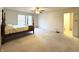 Spacious carpeted bedroom with a four poster bed, ceiling fan, and natural light at 6896 Maywood Cir, Avon, IN 46123