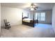 Spacious bedroom with a four-poster bed, rocking chair, and neutral carpet at 6896 Maywood Cir, Avon, IN 46123