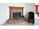 Living room fireplace featuring brick surround and wood mantle at 6896 Maywood Cir, Avon, IN 46123
