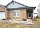 Inviting brick home with a welcoming front porch, sidewalk, and garden accent at 6896 Maywood Cir, Avon, IN 46123