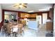 Traditional kitchen featuring wood cabinets, central island, and adjacent dining area at 6896 Maywood Cir, Avon, IN 46123