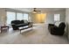 Bright living room featuring a ceiling fan and view to the front entry door at 6896 Maywood Cir, Avon, IN 46123