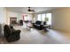 Bright living room with a fireplace, ceiling fan, and views into the dining area at 6896 Maywood Cir, Avon, IN 46123