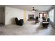 Spacious living room with a fireplace, ceiling fan, and large windows for natural light at 6896 Maywood Cir, Avon, IN 46123