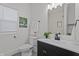 Stylish bathroom with a black vanity, white countertop, and updated fixtures at 729 W 32Nd St, Indianapolis, IN 46208