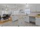 Bright kitchen featuring white cabinets, butcher block countertops, and an open dining area at 729 W 32Nd St, Indianapolis, IN 46208