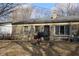 Back exterior of stone house featuring a patio area with grill and lots of space at 7625 E 35Th St, Indianapolis, IN 46226