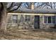 Rear exterior view of house with stone facade and large backyard at 7625 E 35Th St, Indianapolis, IN 46226