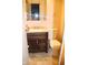 Bathroom featuring a brown vanity with light granite counter and tile floors at 7625 E 35Th St, Indianapolis, IN 46226
